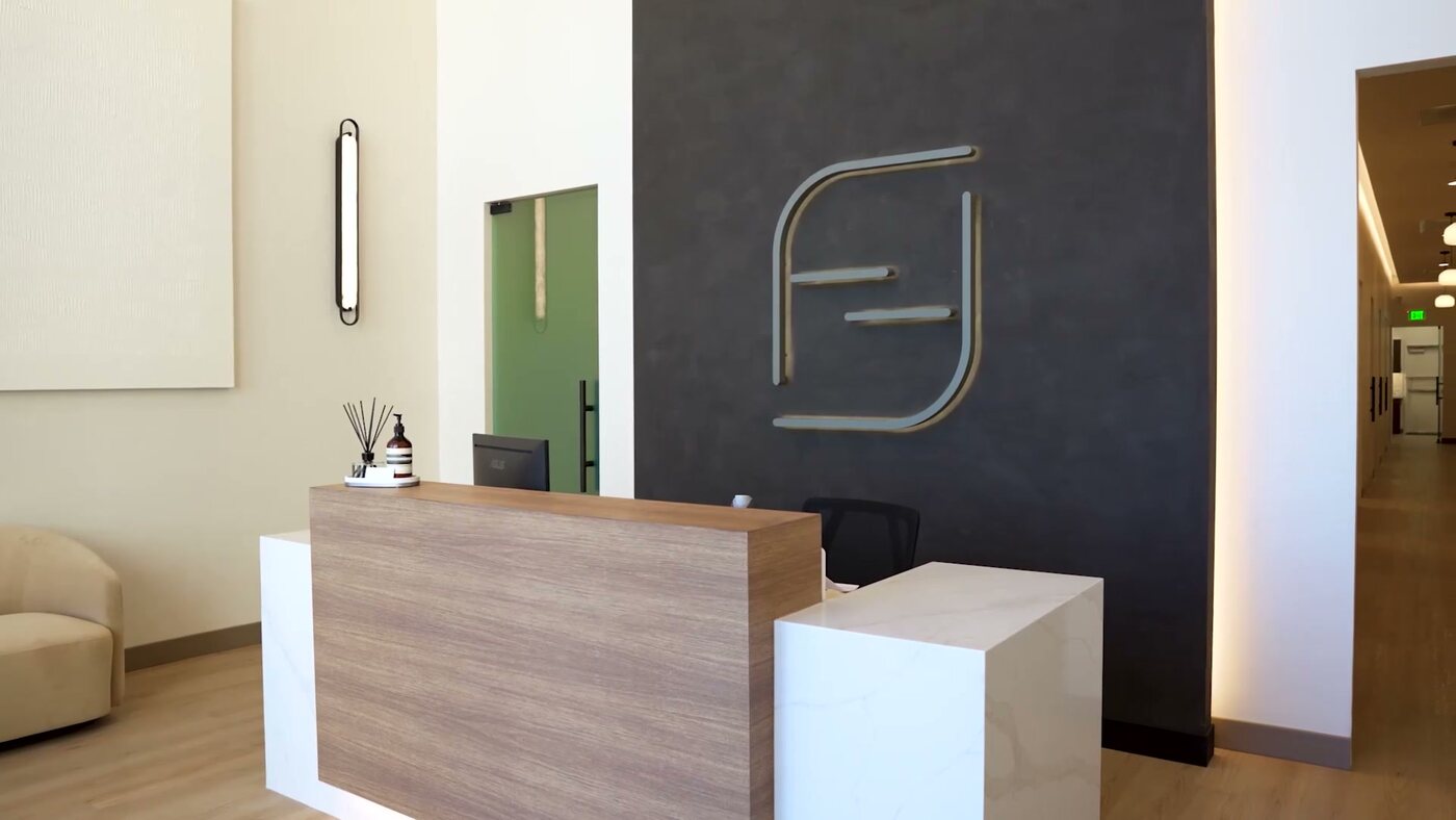 Reception at Form + Function Dental Aesthetics, with the mark cut into the wall